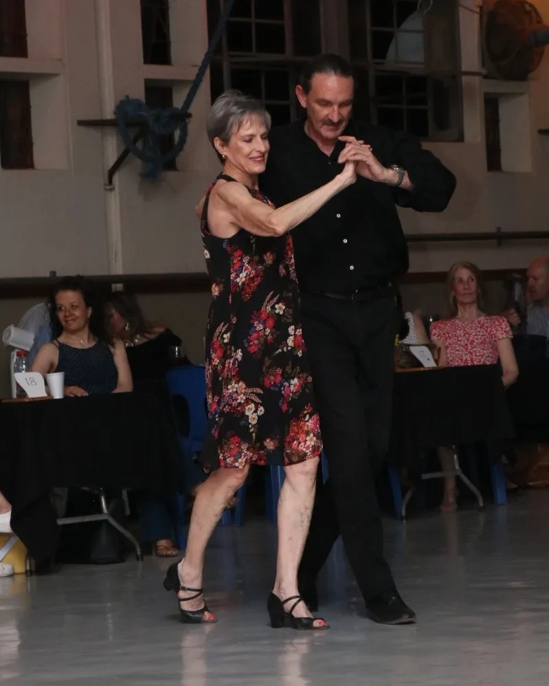 Gideon Stander teaching a social dance step in Centurion Dance instructor Gideon Stander leading a student through a ballroom promenade step on the social floor in Centurion