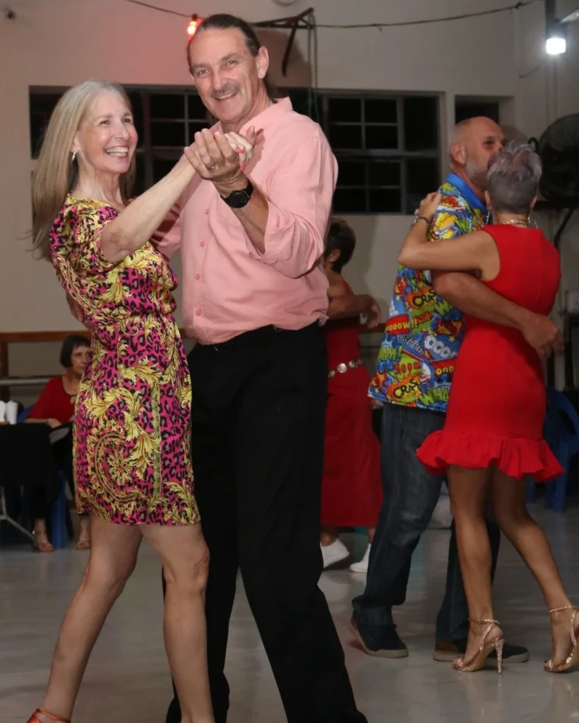 Gideon Stander — 30 years teaching social dance in Centurion Gideon Stander, founder of House of Dance LABDS, smiling mid-step with a student during a social dance evening in Centurion
